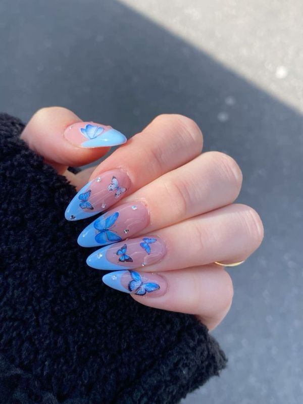 Long Blue French Tip Nails With Stars and Butterflies